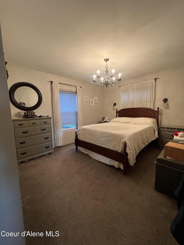 carpeted bedroom featuring a chandelier