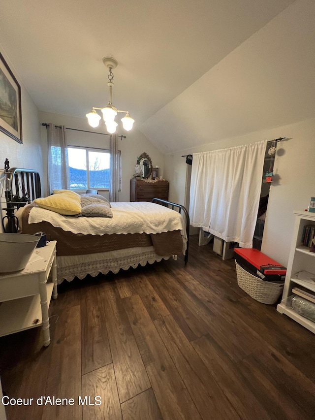 bedroom with a notable chandelier, lofted ceiling, and dark hardwood / wood-style floors