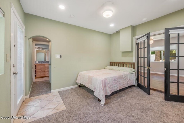 bedroom with light tile patterned flooring and french doors