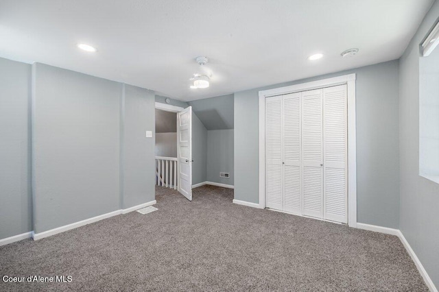 interior space with vaulted ceiling and carpet flooring