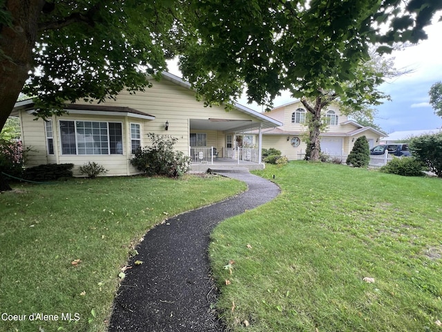 view of front of property featuring covered porch and a front lawn