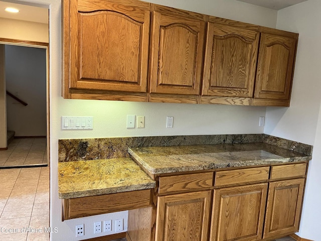 kitchen with dark stone countertops and light tile patterned floors