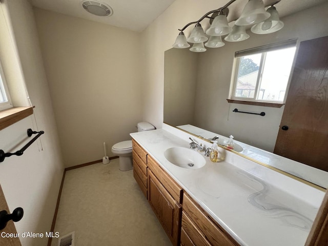 bathroom with toilet and vanity