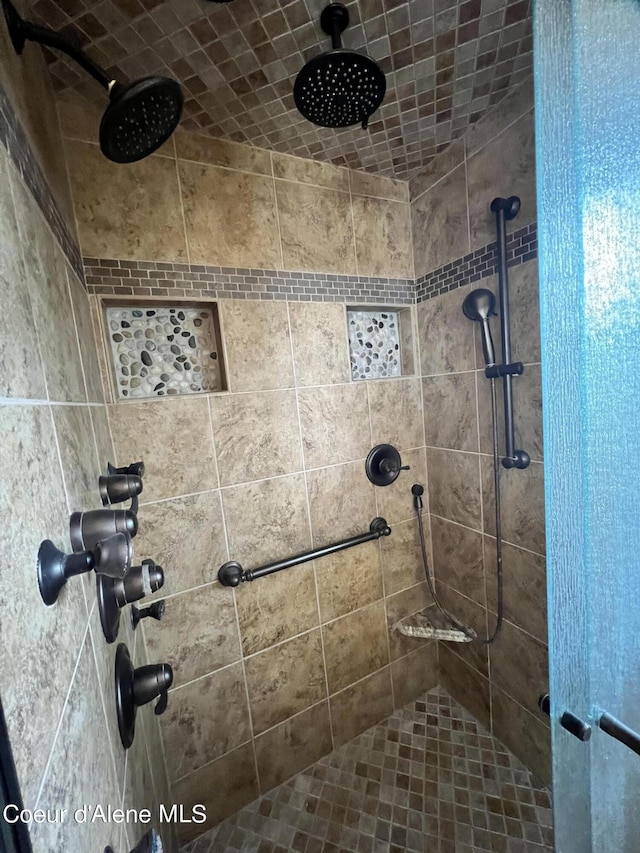 bathroom with a tile shower