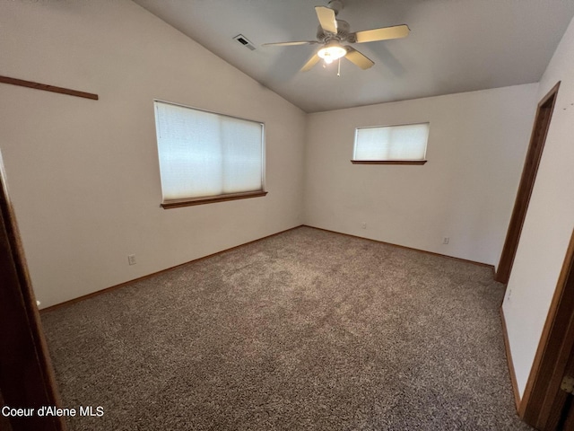 carpeted empty room featuring ceiling fan and vaulted ceiling