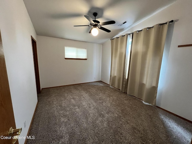 carpeted spare room with ceiling fan