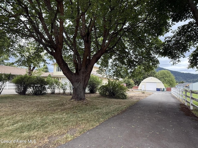 6344 N Colfax St, Dalton Gardens, ID 83815 - view of yard featuring a garage, a mountain view, and an outbuilding