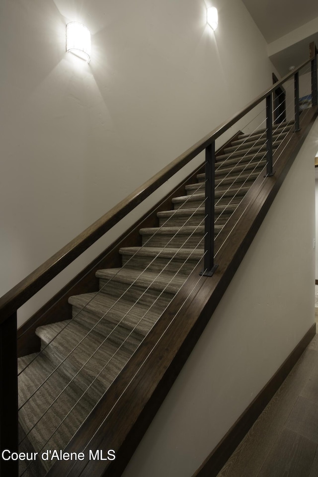 stairway with hardwood / wood-style floors