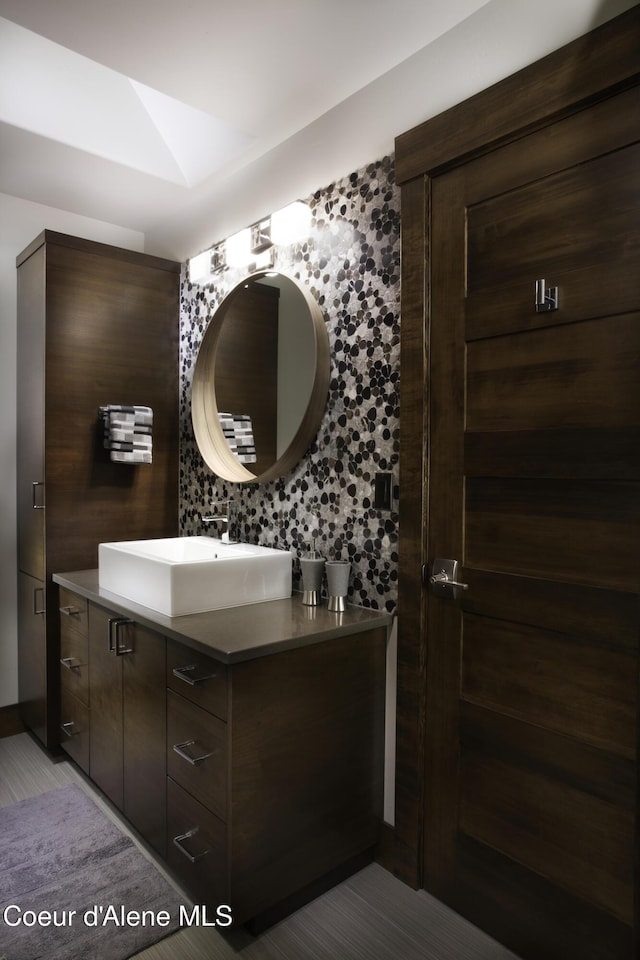 bathroom featuring vanity and decorative backsplash