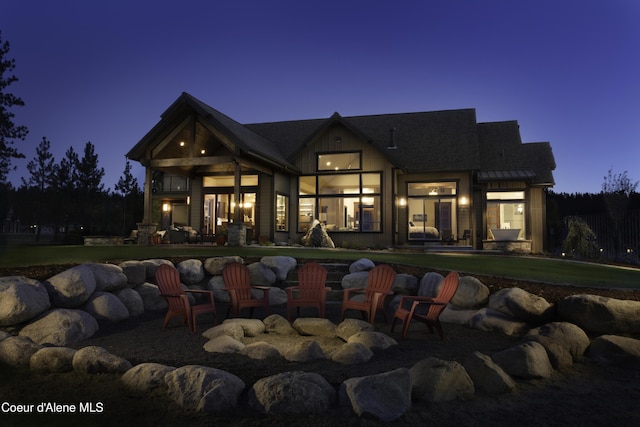 view of back house at dusk