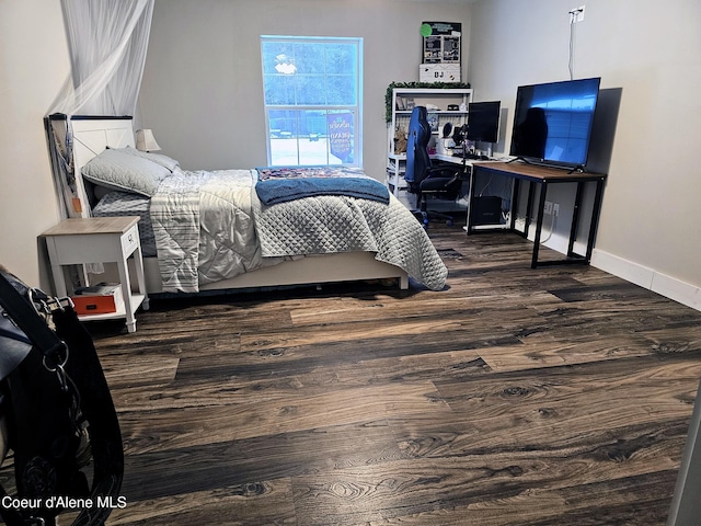 bedroom with dark wood-type flooring