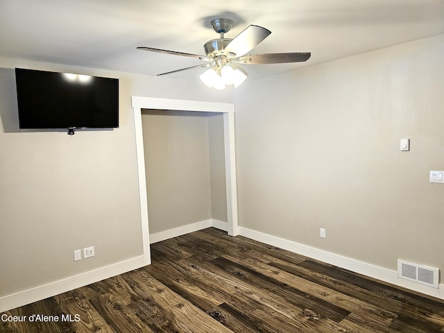 unfurnished room with dark hardwood / wood-style flooring and ceiling fan