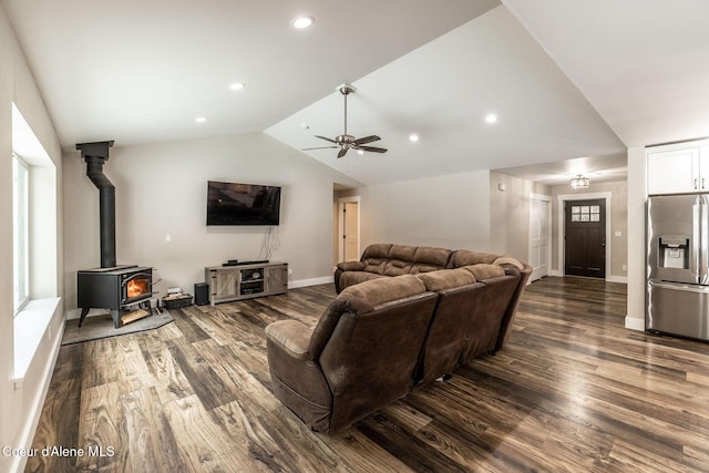 living room with baseboards, wood finished floors, ceiling fan, and vaulted ceiling