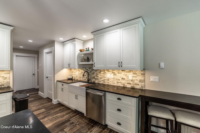 kitchen with a sink, decorative backsplash, open shelves, stainless steel dishwasher, and dark countertops