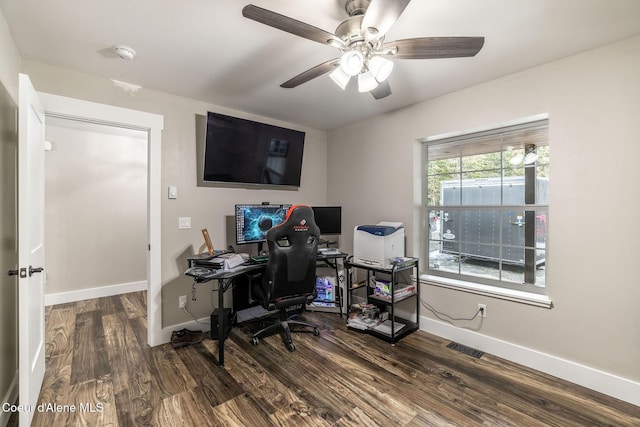 office area featuring a ceiling fan, visible vents, wood finished floors, and baseboards