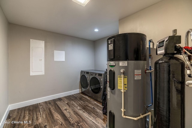 clothes washing area with washing machine and dryer, electric panel, laundry area, water heater, and wood finished floors