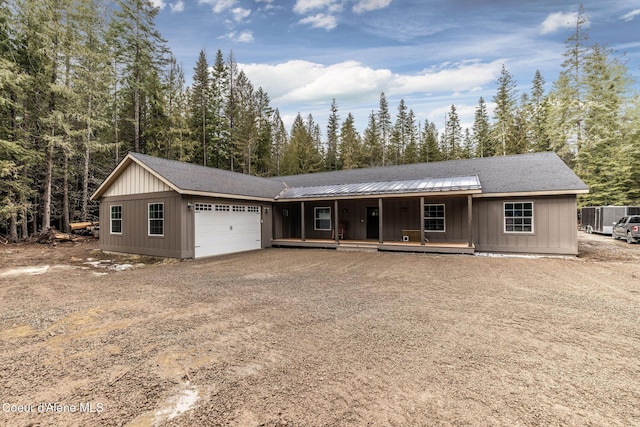 ranch-style home with covered porch, driveway, and an attached garage