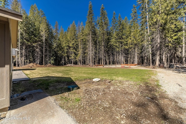 view of yard with a forest view