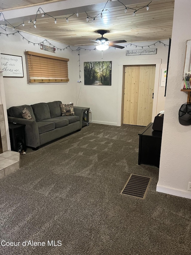 carpeted living room with ceiling fan and wood ceiling