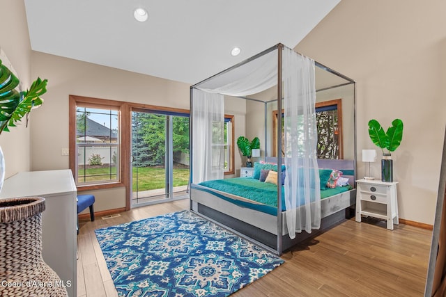 bedroom featuring access to outside and hardwood / wood-style floors