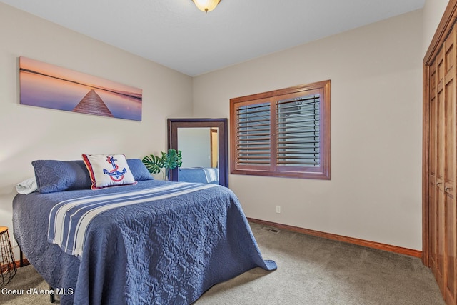 carpeted bedroom with a closet