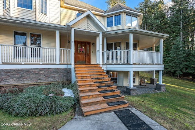 view of exterior entry featuring covered porch