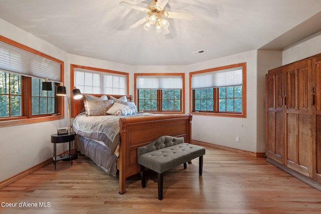 bedroom with ceiling fan and light hardwood / wood-style floors