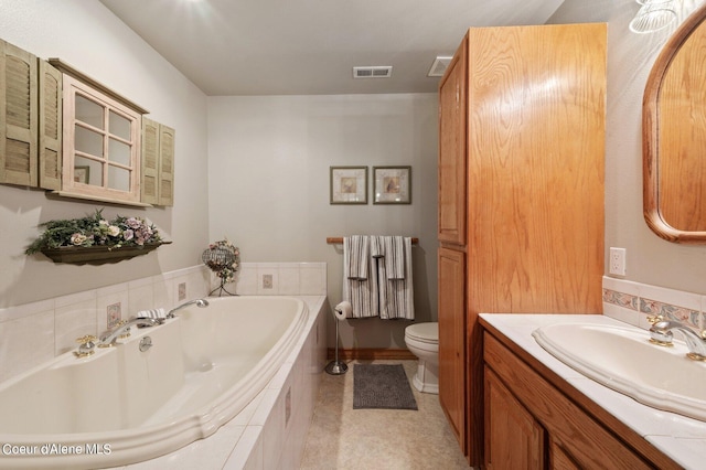 bathroom with a relaxing tiled tub, toilet, and vanity