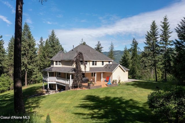 rear view of property with a yard and a patio