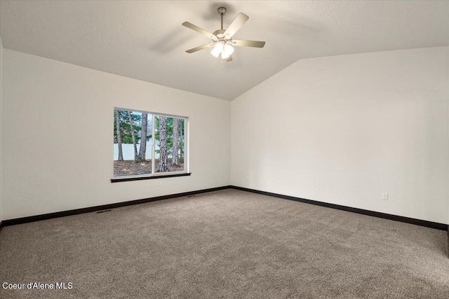 spare room featuring carpet flooring, ceiling fan, and lofted ceiling