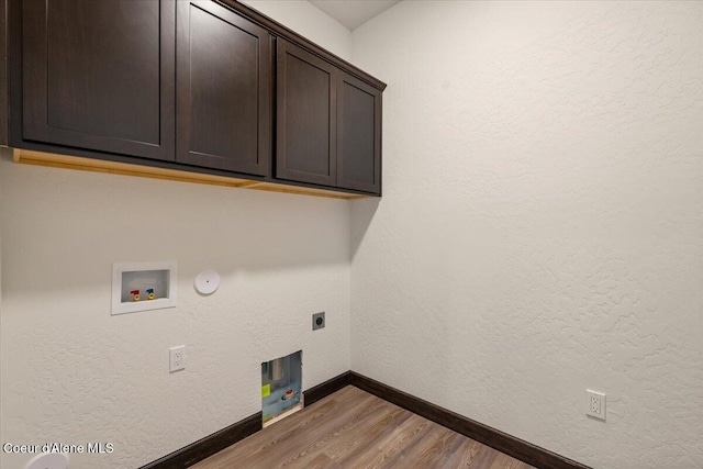 laundry room with cabinets, hookup for a washing machine, electric dryer hookup, wood-type flooring, and hookup for a gas dryer