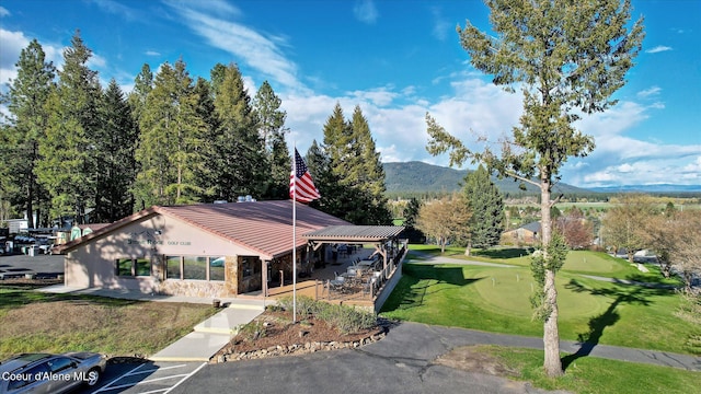 exterior space featuring a mountain view and a front yard