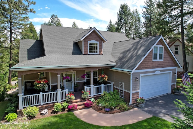 view of front of home featuring covered porch and a garage