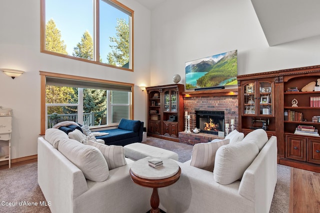 living room with a high ceiling and a brick fireplace