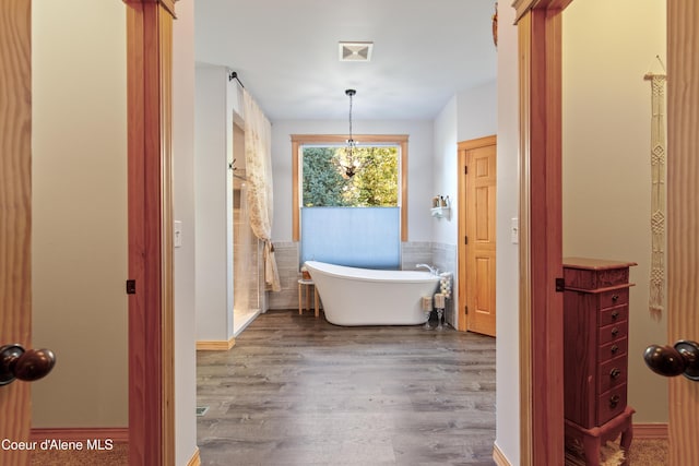 bathroom featuring a washtub and hardwood / wood-style flooring