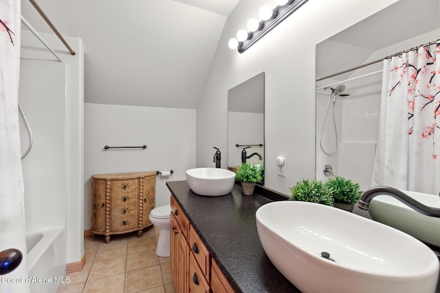 full bathroom featuring tile patterned floors, vanity, vaulted ceiling, shower / bathtub combination with curtain, and toilet