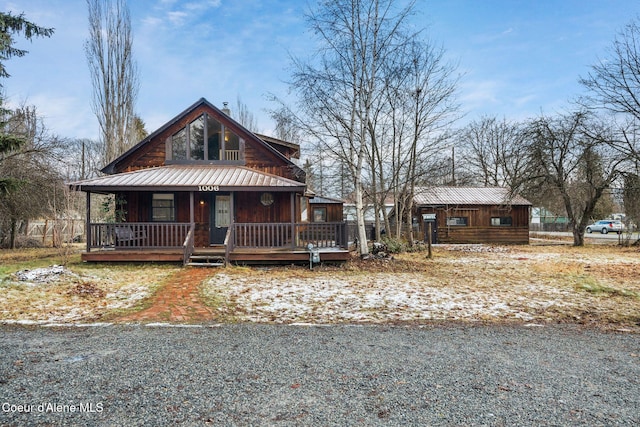 rustic home with a porch and metal roof