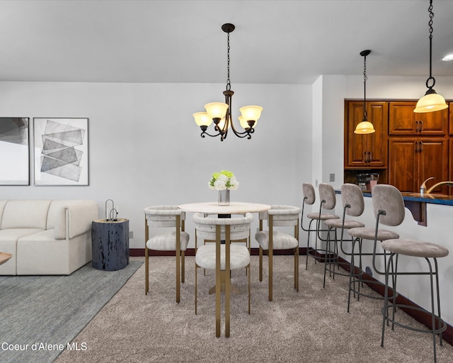 dining space featuring a notable chandelier and sink