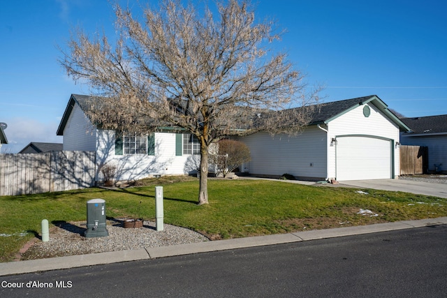 ranch-style house featuring a front yard and a garage