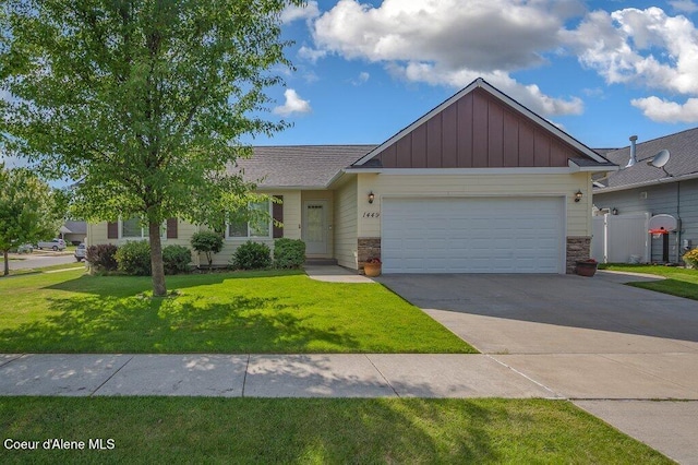 1449 N Moonstone St, Post Falls, ID 83854 - view of front of home featuring board and batten siding, an attached garage, a front yard, concrete driveway, and stone siding
