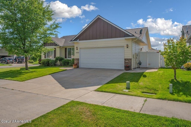 1449 N Moonstone St, Post Falls, ID 83854 - view of front of property featuring board and batten siding, an attached garage, a front lawn, and stone siding