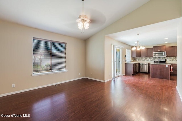 1449 N Moonstone St, Post Falls, ID 83854 - unfurnished living room featuring a ceiling fan, a chandelier, dark wood-type flooring, and vaulted ceiling