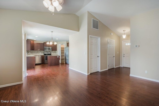 1449 N Moonstone St, Post Falls, ID 83854 - unfurnished living room with a chandelier, ceiling fan, dark wood finished floors, and high vaulted ceiling