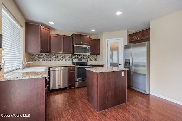 1449 N Moonstone St, Post Falls, ID 83854 - kitchen featuring stainless steel appliances, dark wood-type flooring, decorative backsplash, a center island, and recessed lighting