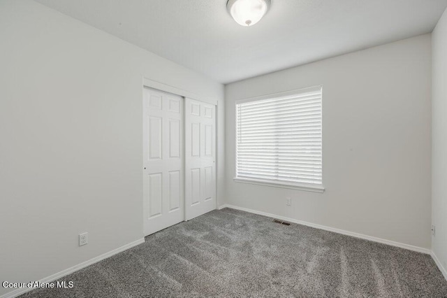 1449 N Moonstone St, Post Falls, ID 83854 - unfurnished bedroom featuring carpet flooring and a closet