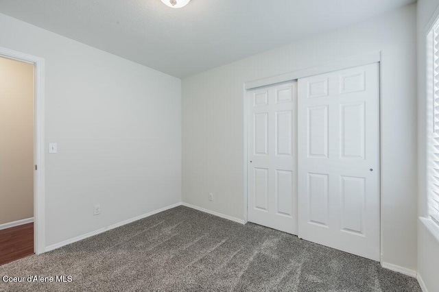1449 N Moonstone St, Post Falls, ID 83854 - unfurnished bedroom with dark carpet and a closet