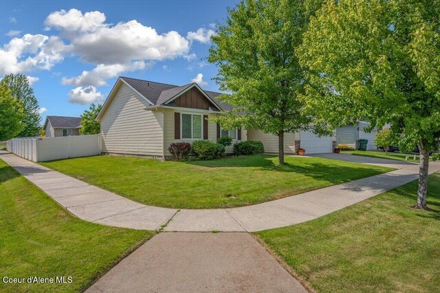 1449 N Moonstone St, Post Falls, ID 83854 - view of front of home featuring driveway, an attached garage, and board and batten siding