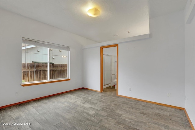 empty room featuring hardwood / wood-style flooring and a healthy amount of sunlight