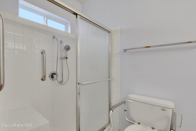 bathroom with toilet and an enclosed shower