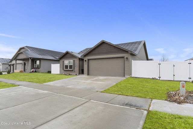 single story home with a garage and a front lawn